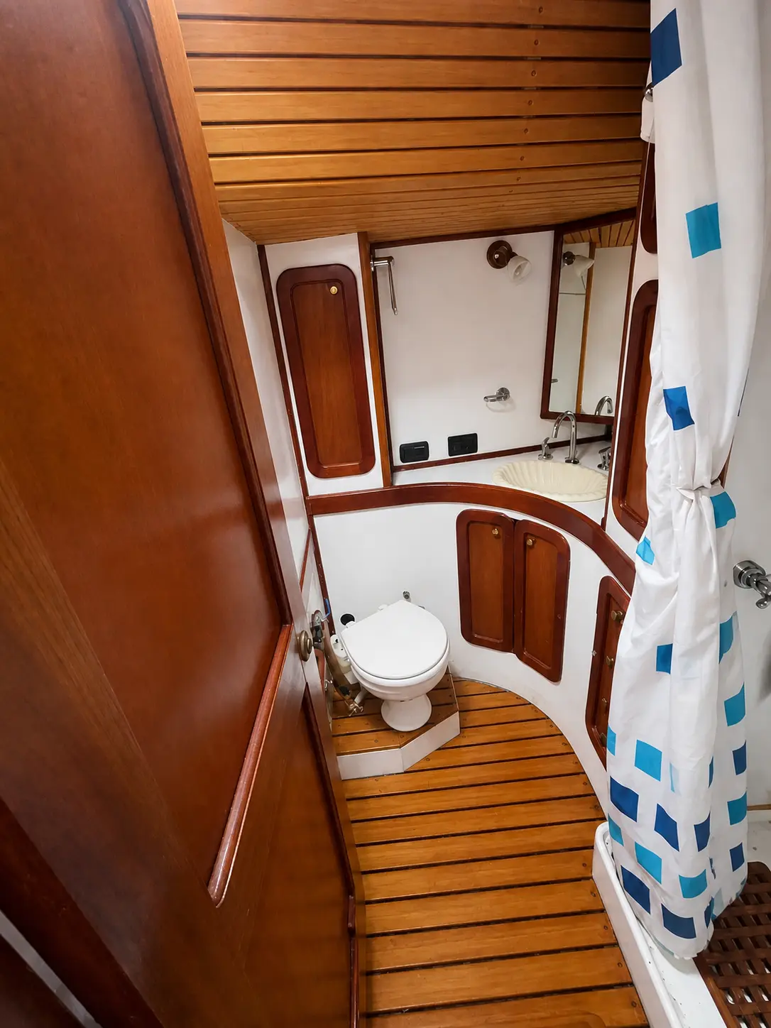 Marine bathroom with toilet, basin and shower aboard El Coronel