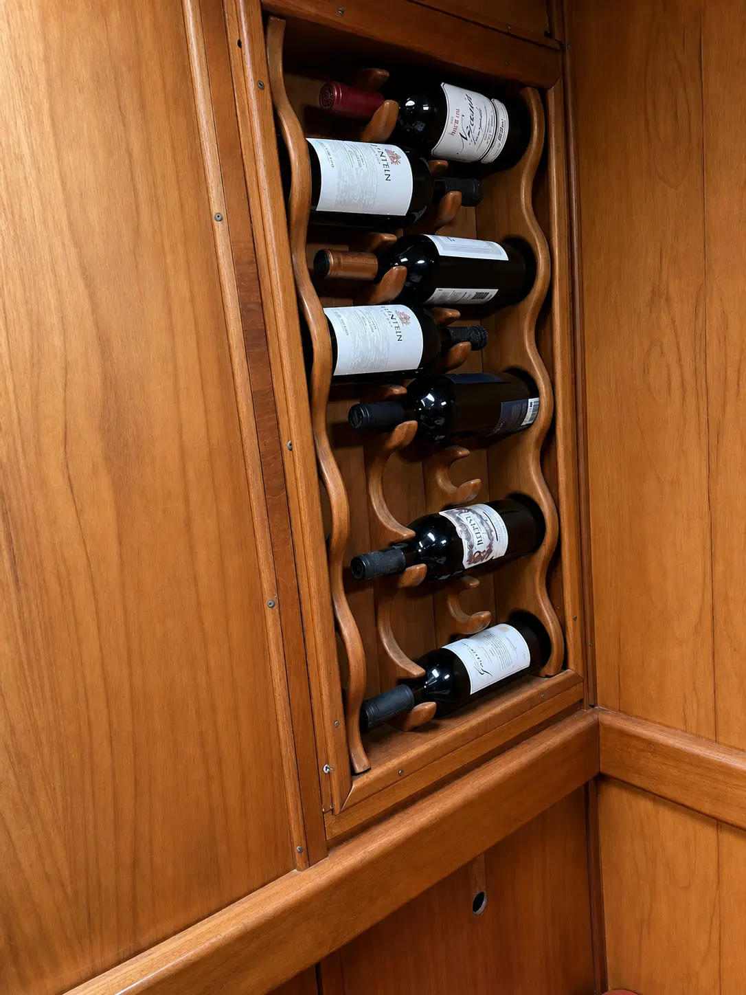 Built-in wooden wine storage aboard El Coronel